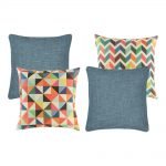 A set of 4 denim and rainbow coloured cushions with diamond and zigzag patterns