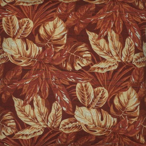 Close up photo of square red orange russet outdoor cushion cover with leaf design