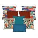 A set of 8 cushions with burnt orange, grey, blue and teal colours and with diamond patterns