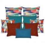 A collection of 9 burnt orange, teal and multi-coloured cushion covers with diamond pattern