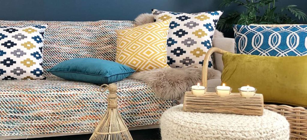 Lovely eclectic boho chic styled room with blue and mustard cushions and funky ornaments