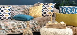 Lovely eclectic boho chic styled room with blue and mustard cushions and funky ornaments