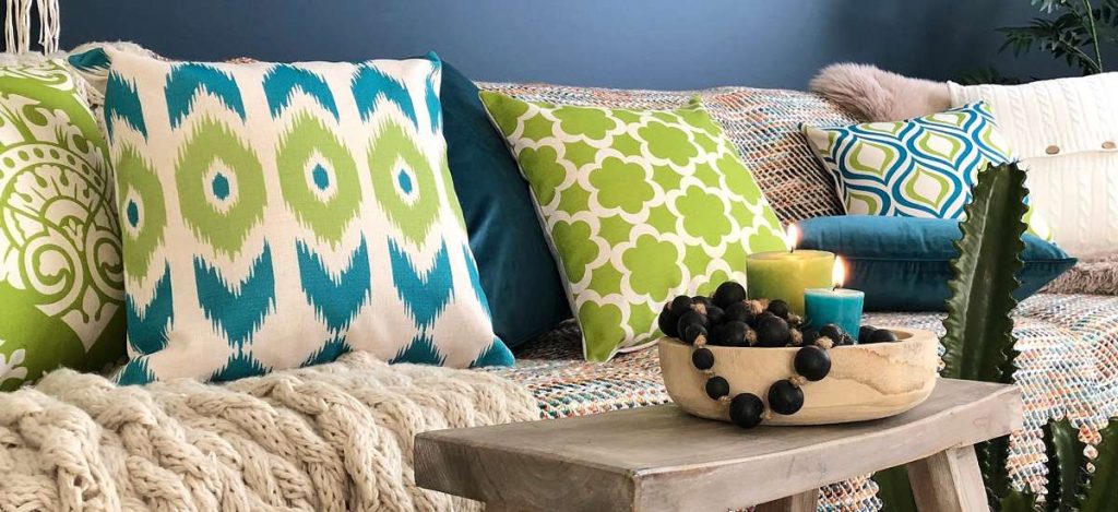 Living room with blue room and green and teal cushions