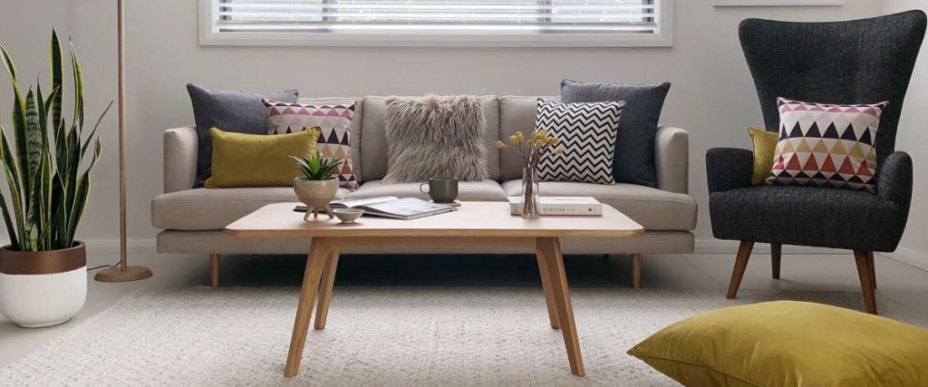 Living room in mid century modern style with cushions in mustard grey chevron and a floor cushion