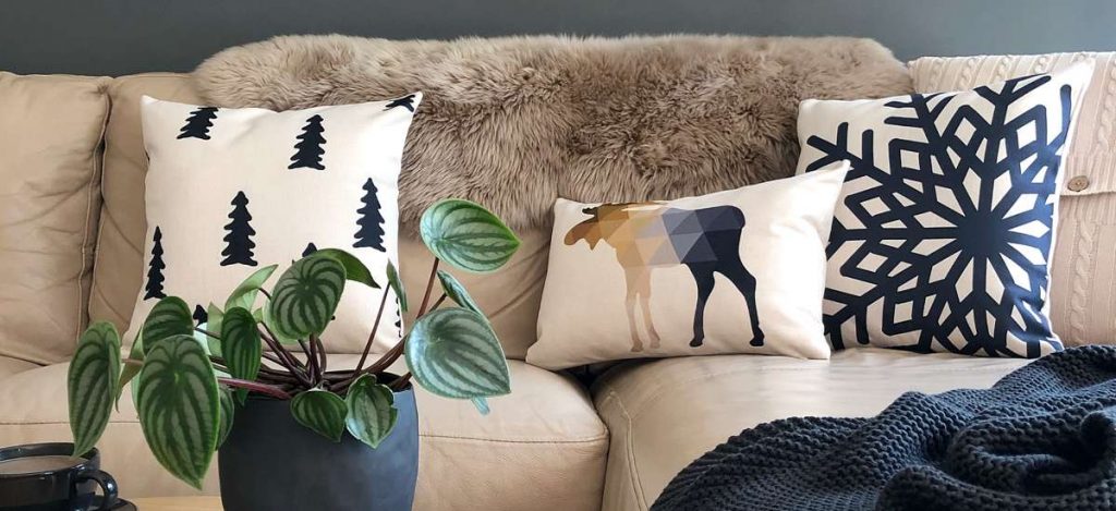 Living room with beige sofa and Scandi styled cushions set up against a fur throw