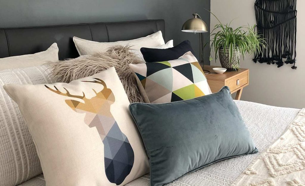 Bedroom with scandi cushions in velvet and cotton linen