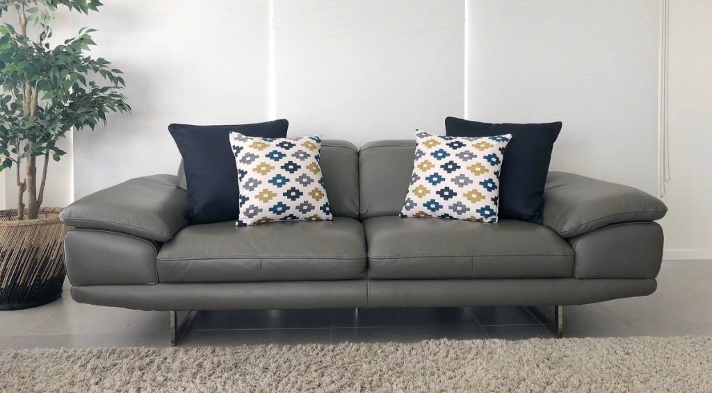 2 seater sofa with two large dark cushions and two smaller prints
