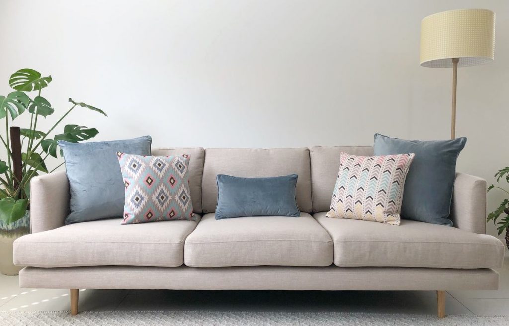 Neutral sofa with soft blue and pink cushions