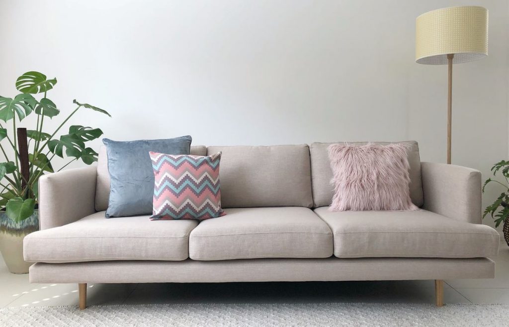 Neutral sofa with cushions in soft blues and pinks