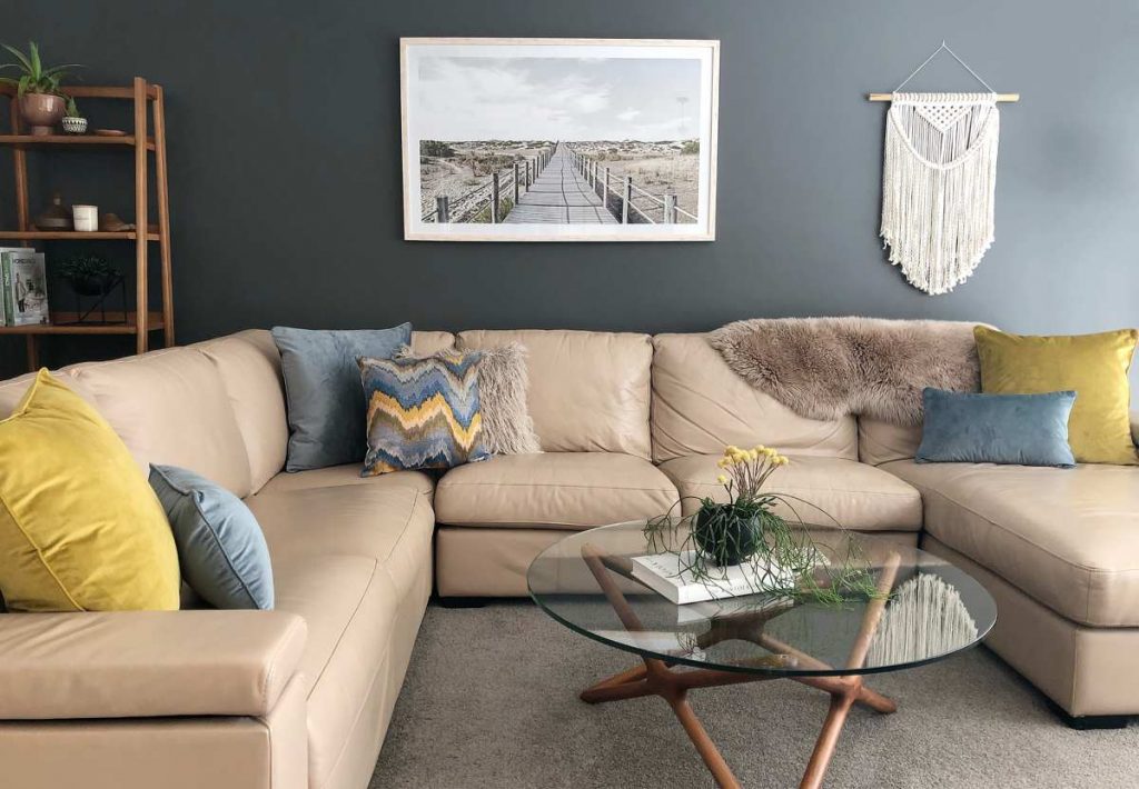 Corner sofa with mustard, soft blue velvet textured cushions