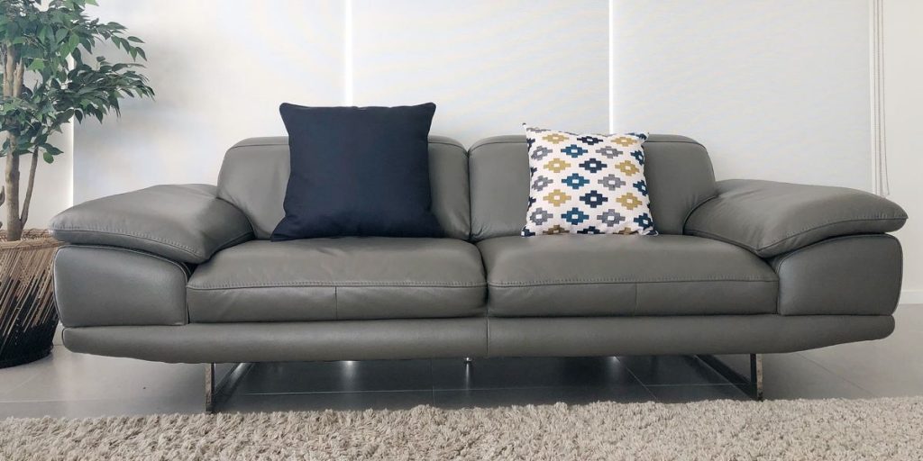 Grey sofa with navy cushion and a patterned cushion