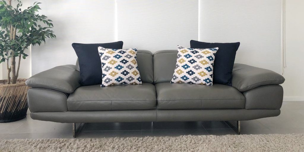 Grey sofa with a 2-2 cushion arrangement in navy and print