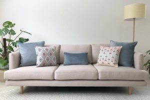 Grey sofa with soft blue and grey cushions