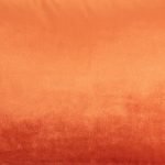 Close up photo of burnt orange rectangular cushion made of velvet fabric