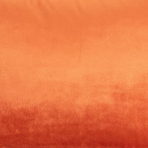 Close up photo of burnt orange rectangular cushion made of velvet fabric