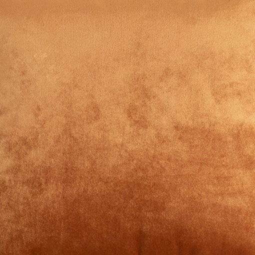 Photo of copper coloured cushion made of velvet fabric