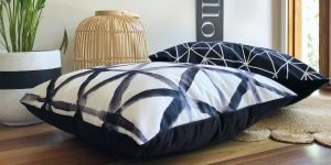 Black and white large floor pillows on a wooden floor