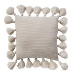 Close up image of alabaster white knit cushion cover with tassels