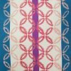 Close up photo of colourful outdoor cushion cover with stripes and geometric flower design