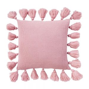 Photo of pink knit cushion with tassels