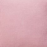 Close up image of pink cushion cover made of knit fabric