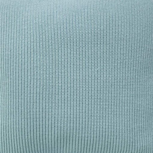 Close up image of teal knit cushion cover with tassels