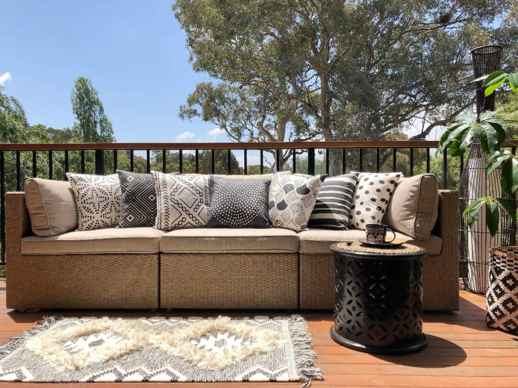 Outdoor lounge area with black and white outdoor cushions in tribal motif