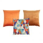 Photo of copper coloured 3 cushion covers in velvet and cotton linen fabric
