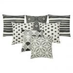 Image of 7 tribal inspired black and white outdoor cushions made of UV and water resistant fabric