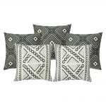 A collection of 5 grey and white outdoor cushions with tribal print