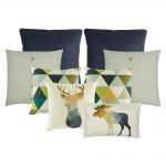 A collection of eight cushion covers in black, white and green colours with triangle and moose design