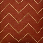Scaled photo of 45cm x 45cm rust coloured mud cloth cushion cover with zigzag print