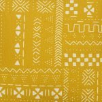 Scaled image of ethnic inspired mud cloth mustard yellow cushion cover