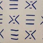 Image of off-white cushion cover with blue mud cloth design