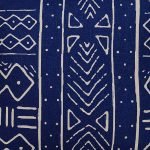 Close up image of navy blue mud cloth cushion cover with ethnic print