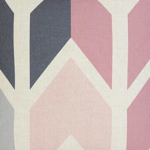 Close up image of chic and modern off-white cushion cover with pink grey and arrows
