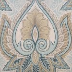 Close up image of pastel blue cushion cover with blue and brown ferns