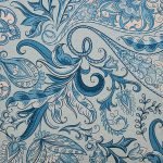 Close up image of elegant teal coloured cushion cover with floral print