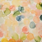 Close up photo of watercolour inspired colourful cushion cover made of cotton linen blend