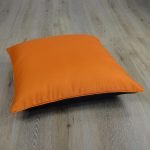 Image of orange and black square floor cushion