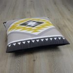 Photo of large square cushion in yellow and grey Aztec motif