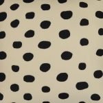 Photo of black and off white outdoor cushion cover with polka dot pattern