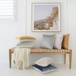 Stunning soft velvet linen cushion covers are beautifully arranged under a piece of artwork.