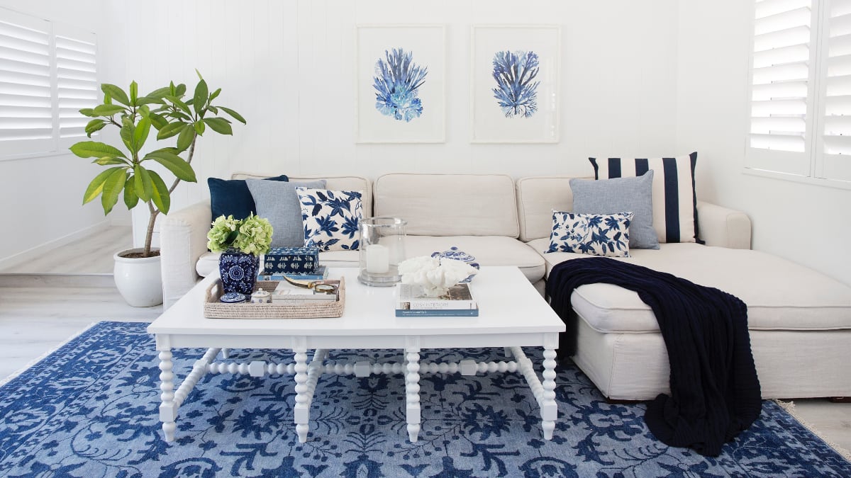 Vivid blue and white living room scene showing how to match couch cushions to your sofa