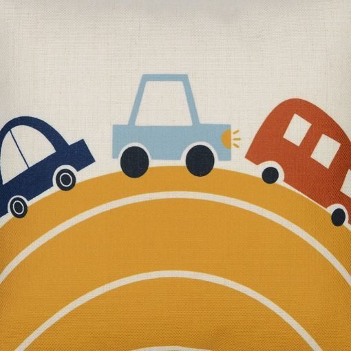 Close up image of square kids cushion cover with yellow hill and blue and red cars