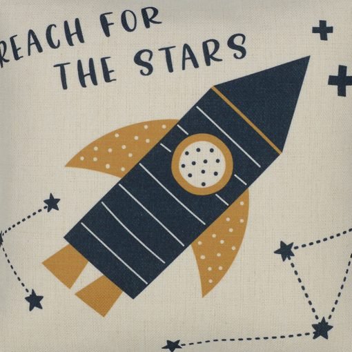 Close up photo of kids cushion with rocket and reach for the stars print