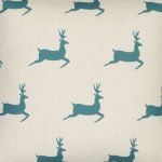 Close up image cotton linen blend cushion cover with teal-coloured stags