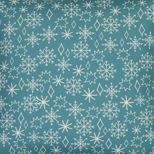 Close up photo of teal cushion cover with winter snowflakes