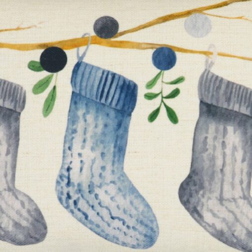 Close up photo of minimalist rectangular cushion cover with socks and mistletoe