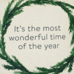 Close up image of Christmas wreath cushion cover made in cotton linen blend fabric